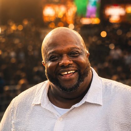 Augusto (Gus) Kennedy, Founder and Executive Director of GUS, smiling in golden evening light